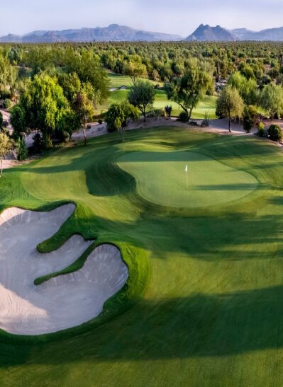 Aerial view of the Wildfire Golf Club green and bunkers with the Phoenix mountains beyond